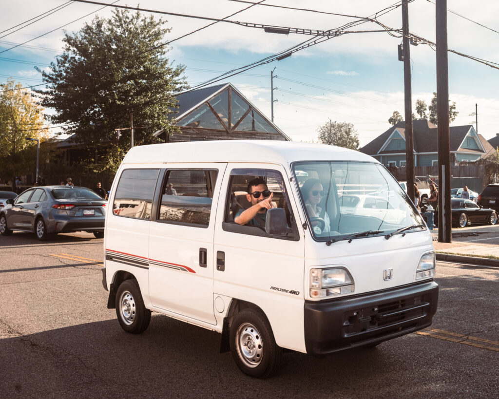 Cool guy driving adorable Japanese van has solved riddle that asks for the meaning of life.